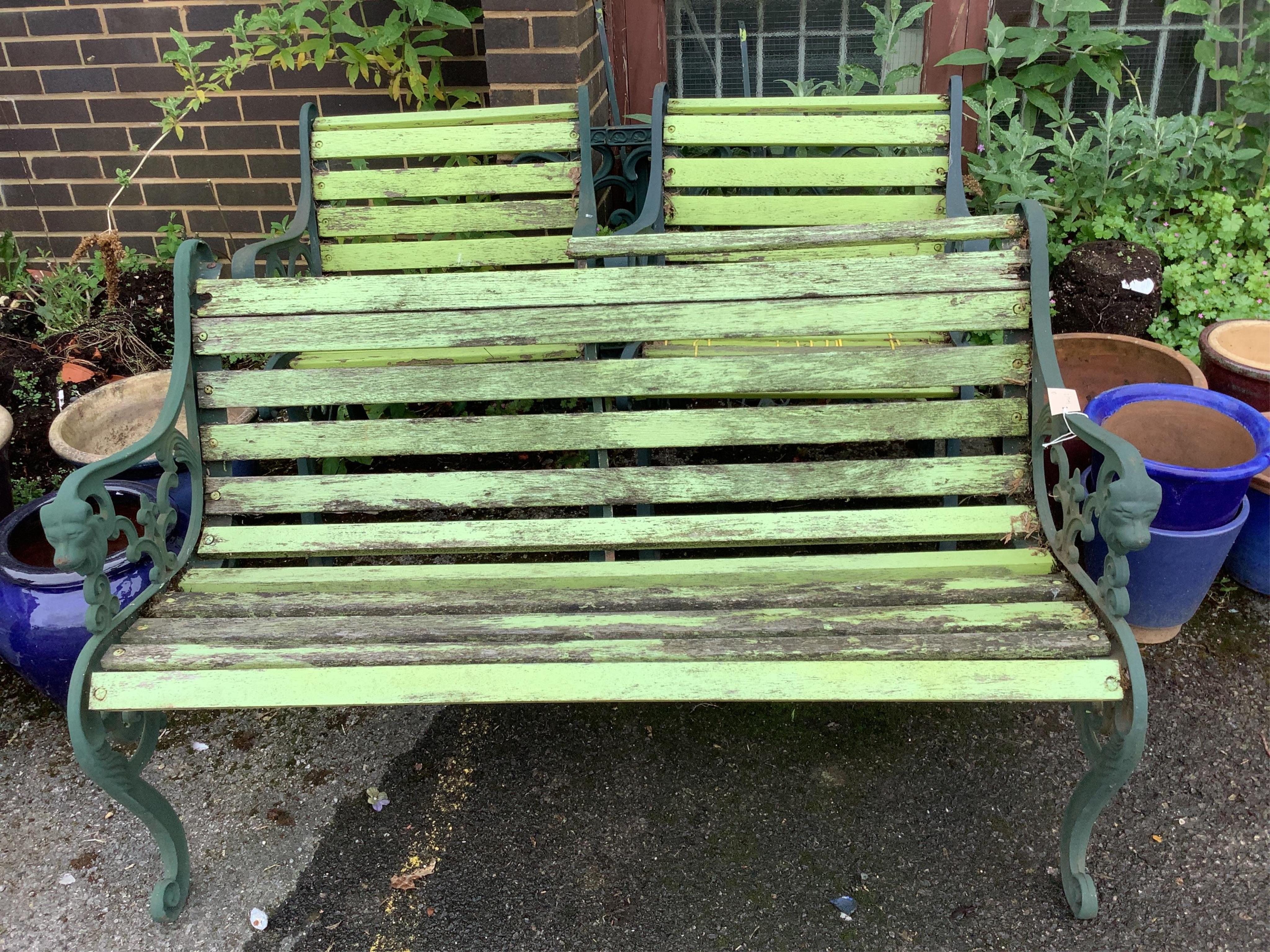 A Victorian style painted aluminium slatted wood three piece garden suite, bench width 128cm, depth 60cm, height 76cm